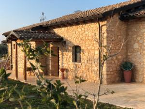 a stone building with a patio in front of it at Tenuta De Luca in Sannicandro Garganico