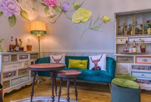 a bar with a blue couch and flowers on the wall at Sali in Alexandroupoli