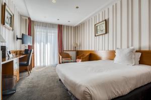 Ένα ή περισσότερα κρεβάτια σε δωμάτιο στο Hotel Le Berry