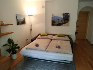 a bedroom with a bed with two pillows on it at Appartment Trojer in Merano