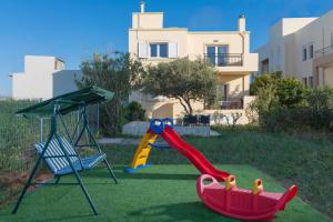 a playground with a slide and a swing at Casa Di Mario in Kokkini Khanion