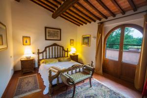 a bedroom with a bed and a large window at Podere Sionne in Chiusi