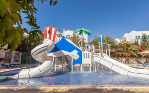 a water slide in a pool at a resort at Le Corail Apart'Hotel & Splash Park in Hammamet