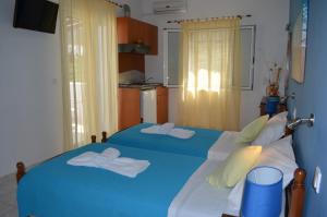 a bedroom with two beds with towels on them at Athena Kythera in Dhiakofti