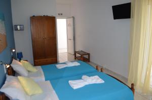 a bedroom with two beds with towels on them at Athena Kythera in Dhiakofti