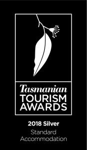 a sign for a tourism tourism awards with a woman at Hobart Hideaway Pods in Kingston