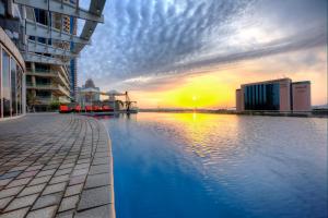 a view of a pool in a city at sunset at Tamani Marina Hotel & Apartments in Dubai +43 photos