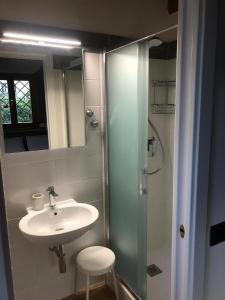 a bathroom with a sink and a glass shower at Bellavista Prile in Castiglione della Pescaia +31 photos