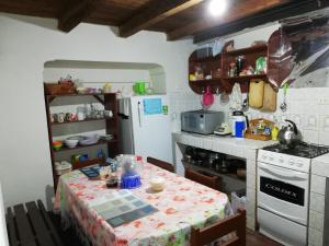 a small kitchen with a table and a stove at Aventura Chachapoyas Backpackers in Chachapoyas
