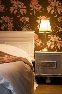 een slaapkamer met een bed en een lamp op een nachtkastje bij sleeping in bruges in Brugge