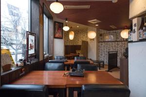 a restaurant with a table and chairs and a table and chairs sidx sidx at SONIC APARTMENT HOTEL in Dazaifu
