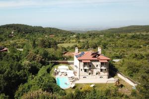 an aerial view of a house with a swimming pool at Evmorfes Villas in Polygryos