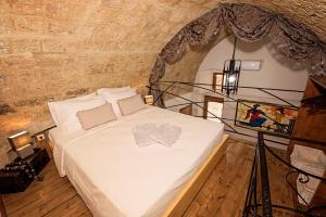 una camera con un letto in un muro di mattoni di Athina house a Città di Rodi
