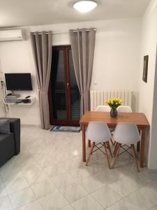 a living room with a wooden table and two chairs at Nela Apartment in Rabac