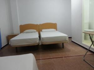 Hostal Casa de Huéspedes San Fernando - Adults Only客房内的一张或多张床位