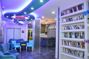 a library with blue chairs and books at Yade Luxe Hotel in Marmaris