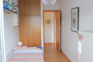 a small room with a bed and a closet at Apartamento Corcubion Playa de Quenxe in Corcubión