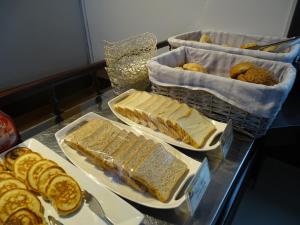 a table topped with trays of bread and pastries at Samana Hotel in Arequipa