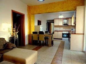 a kitchen and living room with a couch and a table at Cozy apartment in Paradisi in Paradeísion