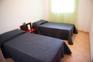 a room with two beds and a window at Apartamento in Santa Susanna +12 photos