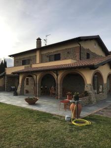 a large brick house with a large patio at Bellavista Prile in Castiglione della Pescaia