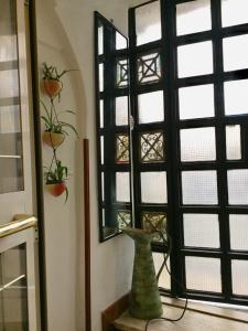 a vase is sitting in front of a window at LaTanaSegreta in Monterotondo