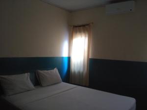 Postel nebo postele na pokoji v ubytování Syifa Homestay