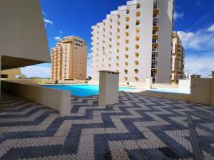 a pool on the roof of a building at Apartment Praia Rocha Varandas Lotus in Portimão