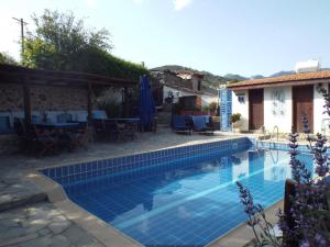 a swimming pool in front of a house at The Pomegranate's House in Ephtagonia