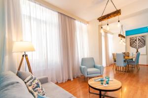 a living room with a couch and chairs and a table at Tinos La belle vie in Tinos