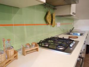 a kitchen counter with a stove and a sink at Cascina Bringin in Mondovì