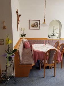 a living room with a table and a couch and a table and a table at Garni Mühlanger in Tirolo