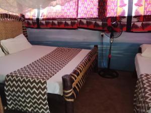 a room with two bunk beds in a room at Soul Breeze Backpackers Diani in Diani Beach