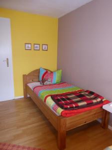 a bedroom with a bed with a colorful blanket on it at Basislager Hohnstein - Familie Lösel in Ehrenberg