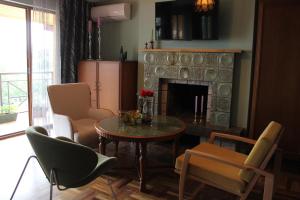 a living room with a table and chairs and a fireplace at 160 degrees in Tbilisi City
