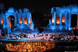 a group of people standing in front of a building at night at Luxury Apartment Federica N 1 Centro Storico di Taormina in Taormina