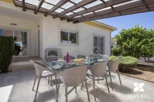 a dining table and chairs on a patio at Villa Maresia in Patroves