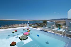 a swimming pool with a view of the ocean at Pyrgos Beach Hotel Apartments in Malia