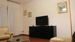 una sala de estar con TV de pantalla plana en una cómoda en B&B Vintage, en Pianoro