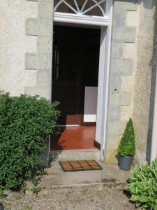 an open door to a house with a plant at Balvraid Lodge B&B in Inverness