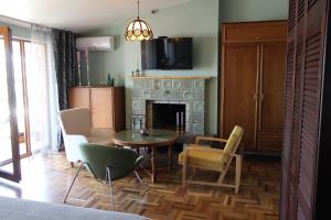a living room with a table and chairs and a fireplace at 160 degrees in Tbilisi City