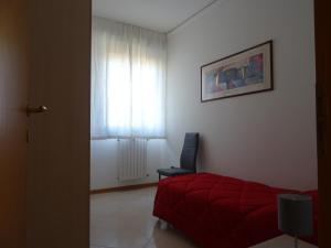 una camera con letto rosso e sedia blu di W LE VACANZE a Rimini