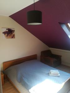 a bedroom with a bed with a purple ceiling at Stary Drahim in Czaplinek