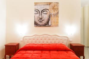 a bedroom with a red bed with a painting on the wall at Su Soi in Càbras +24 photos