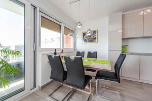 a kitchen and dining room with a table and chairs at Sea the Sunset Apartment in Zadar +16 photos