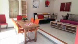 a living room with a table and a couch at gite du devez des bruyéres in Prades