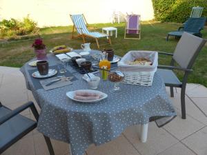 une table avec un chiffon bleu et de la nourriture dans l'établissement LE RUBAN BLEU FACE A LA MER, à Arromanches-les-Bains