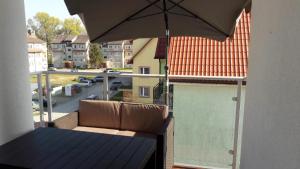 een balkon met een tafel en een parasol bij La Dolce Vita2 in Dziwnówek
