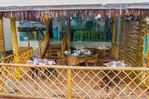 a restaurant with tables and chairs on a deck at Hotel Vila Kebaya in Ilhabela