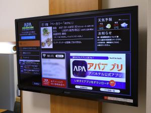 a television screen with a bunch of signs on it at APA Hotel Nishi-Azabu in Tokyo